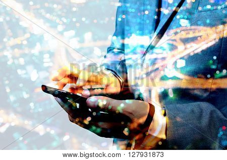 Double Exposure Of Businessman Swipe Mobile Smartphone With Night City