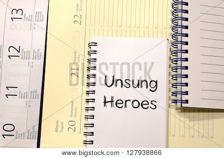 Unsung heroes text concept write on notebook
