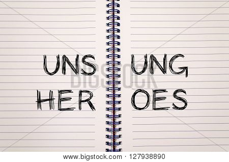 Unsung heroes text concept write on notebook