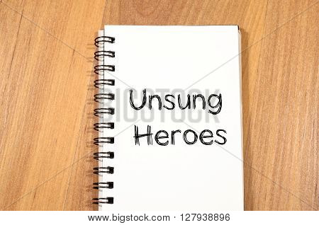 Unsung heroes text concept write on notebook