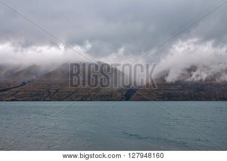 Lake Ohau and Ben Ohau Range on a rainy summer day. South Island New Zealand.