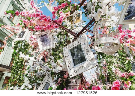 MOSCOW RUSSIA - April 30 2016. Street festival "Moscow Spring" in historical center of Moscow city. Flower decoration of colorful easter fair. People walking on sunny day.