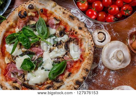 Pizza Capricciosa With Artichoke, Ham And Mushroom On Wood Background