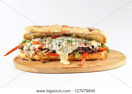 Tasty Beef Steak Sandwich With Onions, Mushroom And Melted Provolone Cheese In A Ciabatta