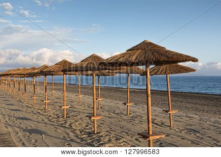 Sunshades at sunset on the beach at Gerani Crete