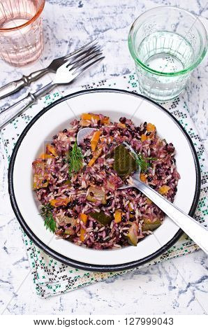 Cooked rice with vegetables and sauce on the plate. Selective focus.