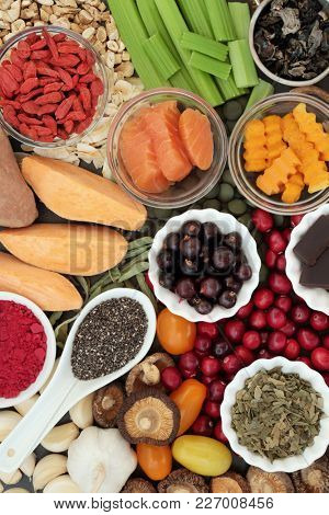 Health food concept for better brain power with fish, fruit, vegetables, seeds and herbs, super foods high in minerals, vitamins, antioxidants, anthocyanins, fibre and omega 3 fatty acids, top view.