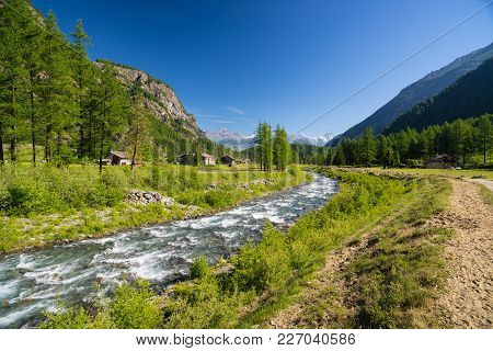 Flowing Transparent Waters On High Altitude Alpine Stream In Idyllic Uncontaminated Environment In T