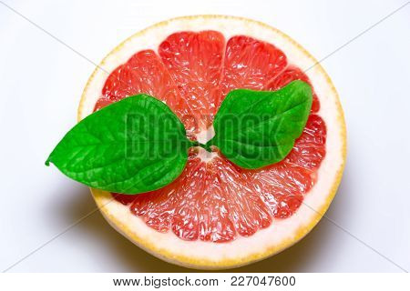 Grapefruit With Slice And Leafs On White Background.