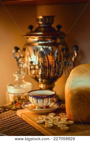 Russian Traditional Samovar With Hot Bread And Ceramic Cup Of Tea