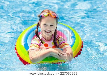 Child In Swimming Pool. Kids Swim. Water Play.