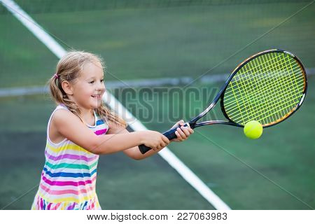Child Playing Tennis On Outdoor Court