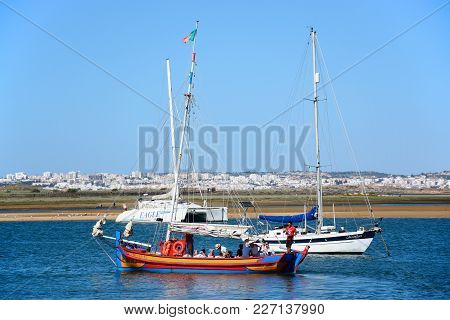 Alvor, Portugal - June 7, 2017 - Tourists Aboard A Wooden Tour Yacht On The Estuary, Alvor, Algarve,
