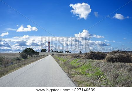 Road To Irrigation Water Tank. Concrete Tower Made For Store Irrigation Water, Vegas Bajas Del Guadi