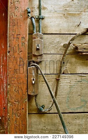 Old Electrical Wiring Is A Fire Hazard In An Old Barn Building Surrounded Bt Carved Initials In The 