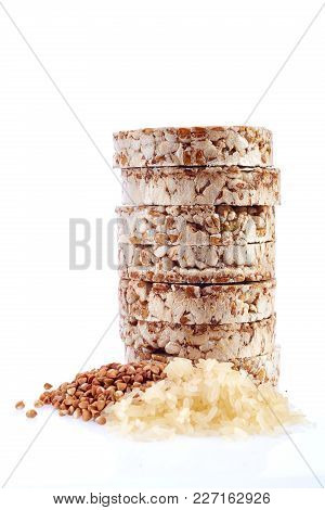 Diet Ricebiscuits Pile With Buckwheat And Rice Grains Isolated On White Background. Healthy Food. He