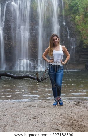Beautiful Young Woman Posing In Front Of The Waterfall Llanos Del Cortez In Costa Rica