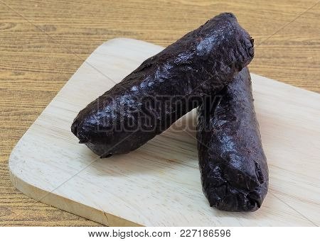 Japanese Cuisine, Traditional Unsliced Japanese Rice Maki Sushi Roll With Nori Seaweed On Cutting Bo
