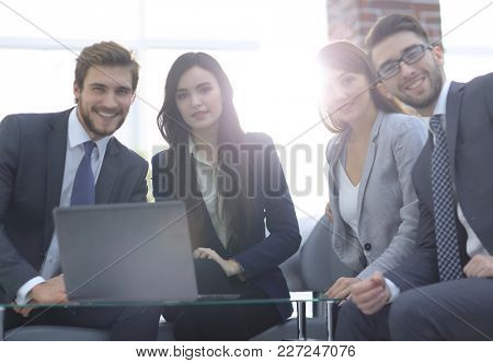 Business people are using a laptop during the conference in offi