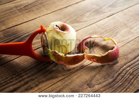 Cleared Apple On A Wooden Background