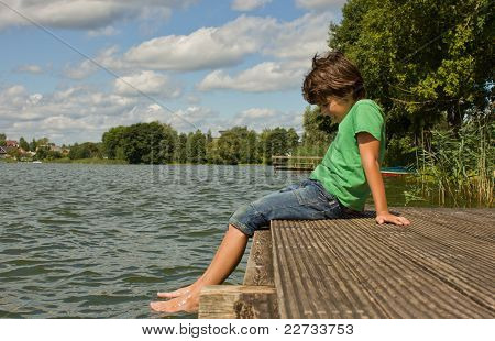 niño relajante al final de muelles