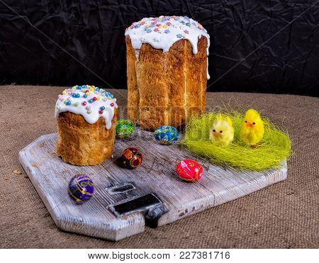 Easter Composition Of Sweet Bread, Paska And Eggs On Wooden Background. Orthodox Kulich. Holidays Br