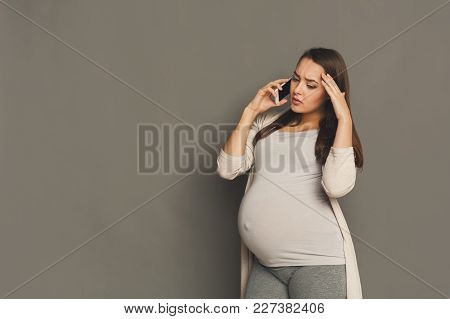 Worried Pregnant Woman Talking On Phone Copy Space. Sad Expectant Lady Having Serious Conversation W