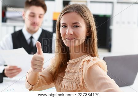 Beautiful Smiling Woman Showing Ok Or Approval Sign With Thumb Up In Creative People Office Closeup.