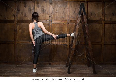 Training Concept. Nice Woman In Gym Training On Ladder