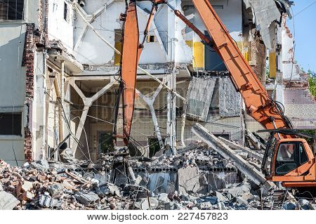 Dismantling Of Building With Heavy Industrial Machine. Demolition Of Industrial Building.