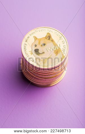 The golden dogecoins on violet background.