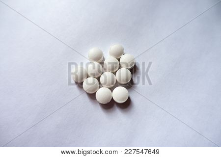 Fistful  Of Small White Vitamin K Tablets