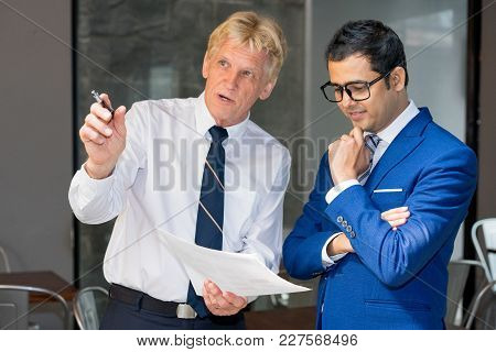 Executive Pointing At Something Out Of Window And Showing Document To Manager. Senior Leader Consult