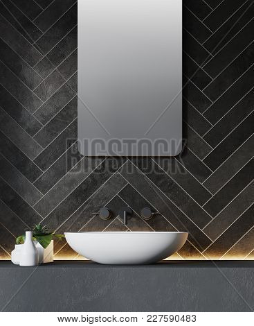 White Bathroom Sink Near A Black Brick Like Wall With A Large Round Mirror Hanging Above It. Side Vi