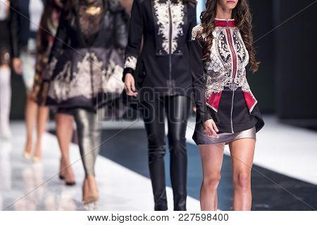 Female Models Walk The Runway In Different Dresses During A Fashion Show. Fashion Catwalk Event Show