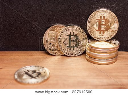 Golden Bitcoin Coins Pile On Wooden Table Black Background