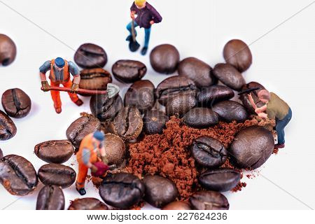 Miniature Figures Working On Coffee Macro Photography On White Background