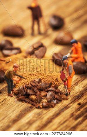 Miniature Figures Working On Instant Coffee Macro Photography On Wood Table
