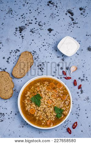 Traditional Spicy Soup With Rice And Vegetables In A Plate On The Table. Selective Focus.