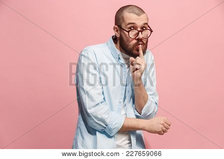Secret, Gossip Concept. Young Man Whispering A Secret Behind Her Hand. Business Man Isolated On Tren