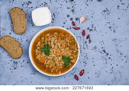Traditional Spicy Soup With Rice And Vegetables In A Plate On The Table. Selective Focus.