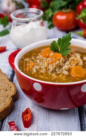 Traditional Spicy Soup With Rice And Vegetables In A Plate On The Table. Selective Focus.