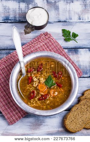 Traditional Spicy Soup With Rice And Vegetables In A Plate On The Table. Selective Focus.