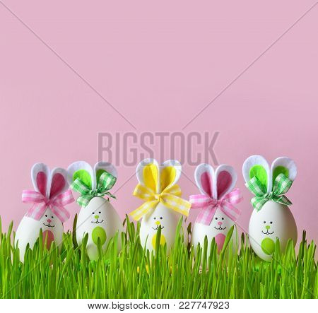 Easter Funny Bunny On Green Grass And Easter Eggs. Easter Background