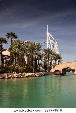 DUBAI, UAE - FEBRUARY, 2018: View on Burj Al Arab, the world only seven stars fotel seen from Madinat Jumeirah, is a luxury resort which include hotels and souk spreding across over 40 hectars.