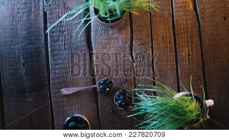 Still Life Of Grapes And Prunes On A Wooden Background