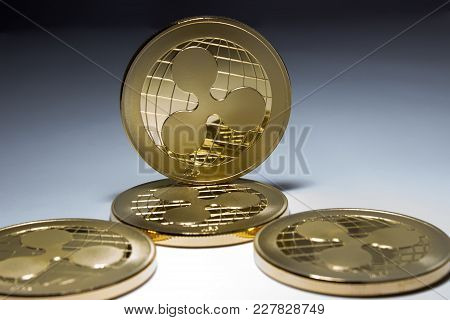 On A Black And White Background Are Gold Coins Of A Digital Crypto  Currency - Ripple. In Addition T