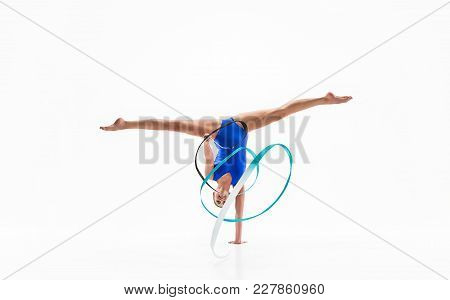 The Portrait Of Beautiful Young Brunette Woman Gymnast Training Calilisthenics Exercise With Blue Ri