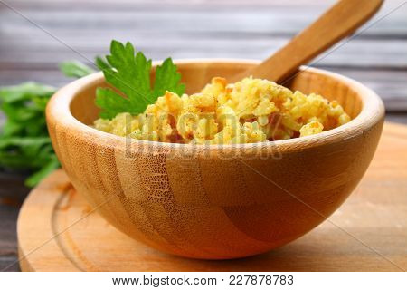 Rice Pilaf With Chicken, Spices And Parsley In A Bowl On A Wooden Table