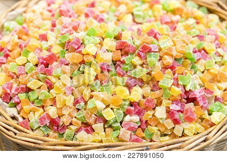 Fresh Multi-colored Candied Fruits In A Wicker Basket.